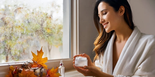 A girl holding a moisturizer.